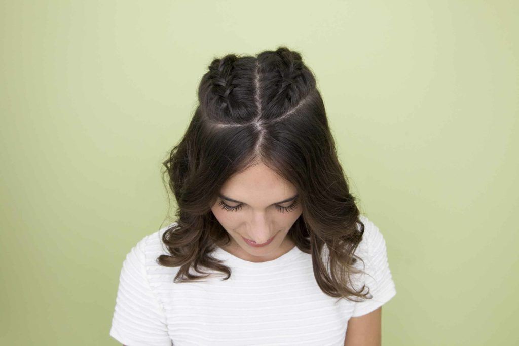 How to do a braid: model shows how to do braids in her dark hair with half up half down french braids
