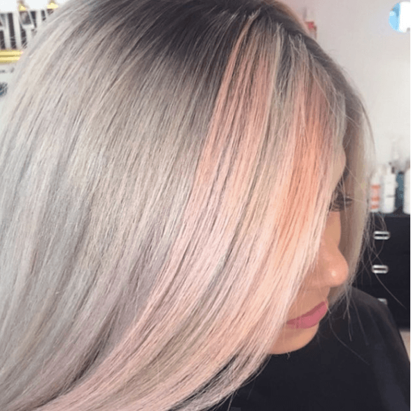 Shades of blonde hair: Woman with straight stray grey and pink pastel hair.