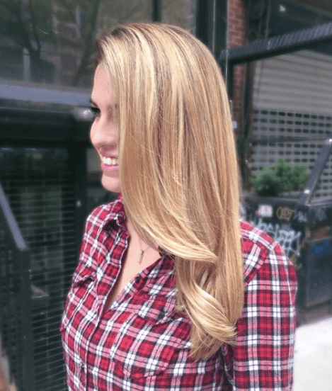 side view of a woman with her long hair worn down in a natural blonde colour