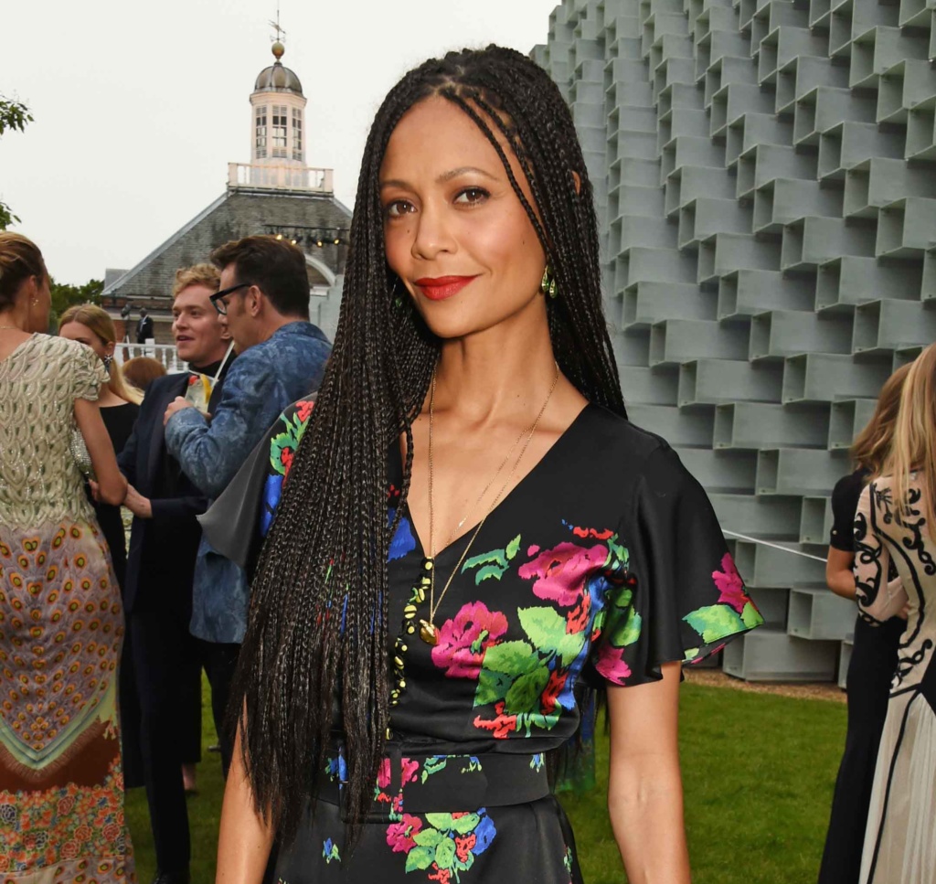 Thandie Newton at the serpentine summer party with long box braids, wearing a black and floral dress