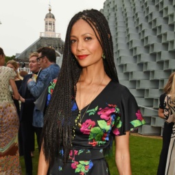 Thandie Newton at the serpentine summer party with long box braids, wearing a black and floral dress