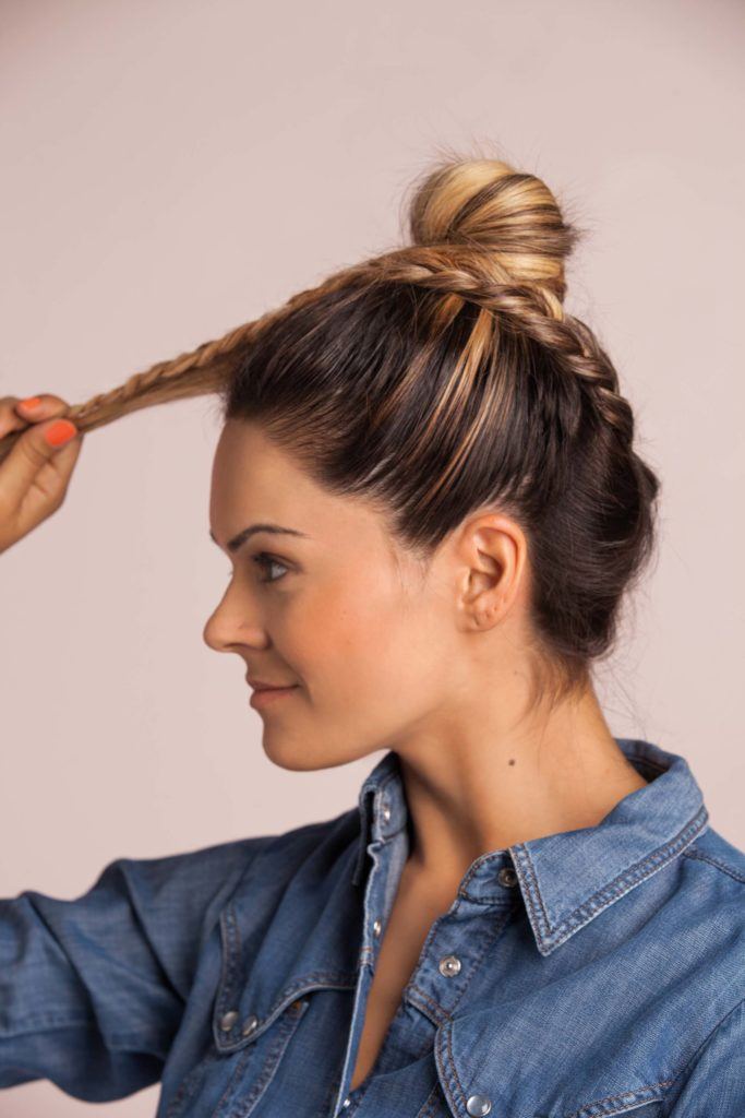 braid top knot: a blonde woman wrapping her braid around her top knot