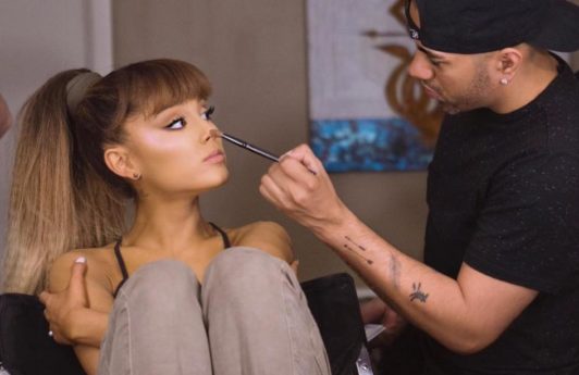 ariana grande with sat in the make up artists chair with her hair worn in her signature ponytail hairstyle with crimped ends