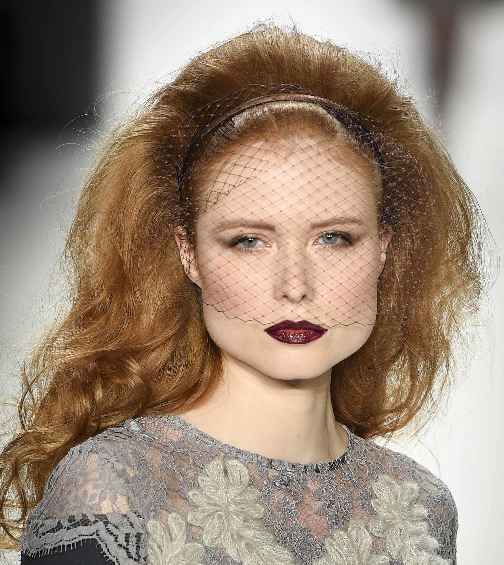 model with golden blonde curly hair in bouffant style wearing black net veil and grey lace floral pattern dress at aw16 fashion week in berlin