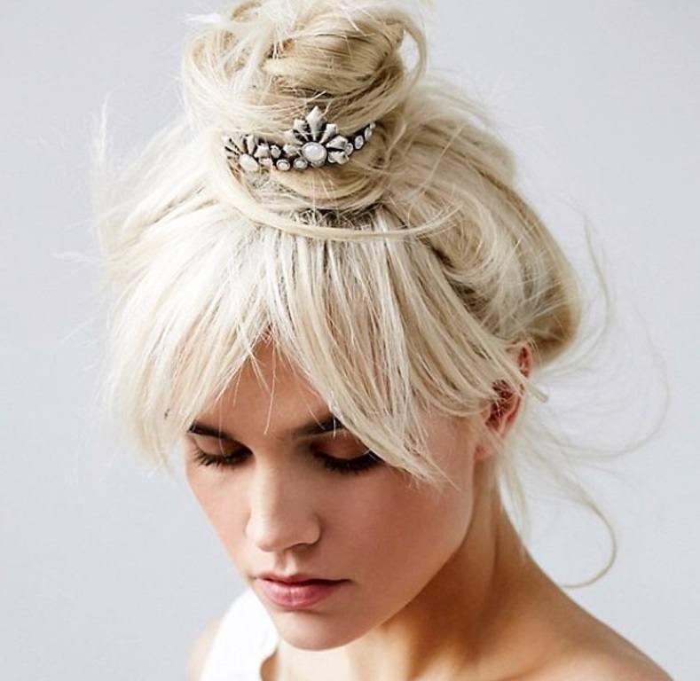 woman with blonde hair styled into an updo with bun cuff