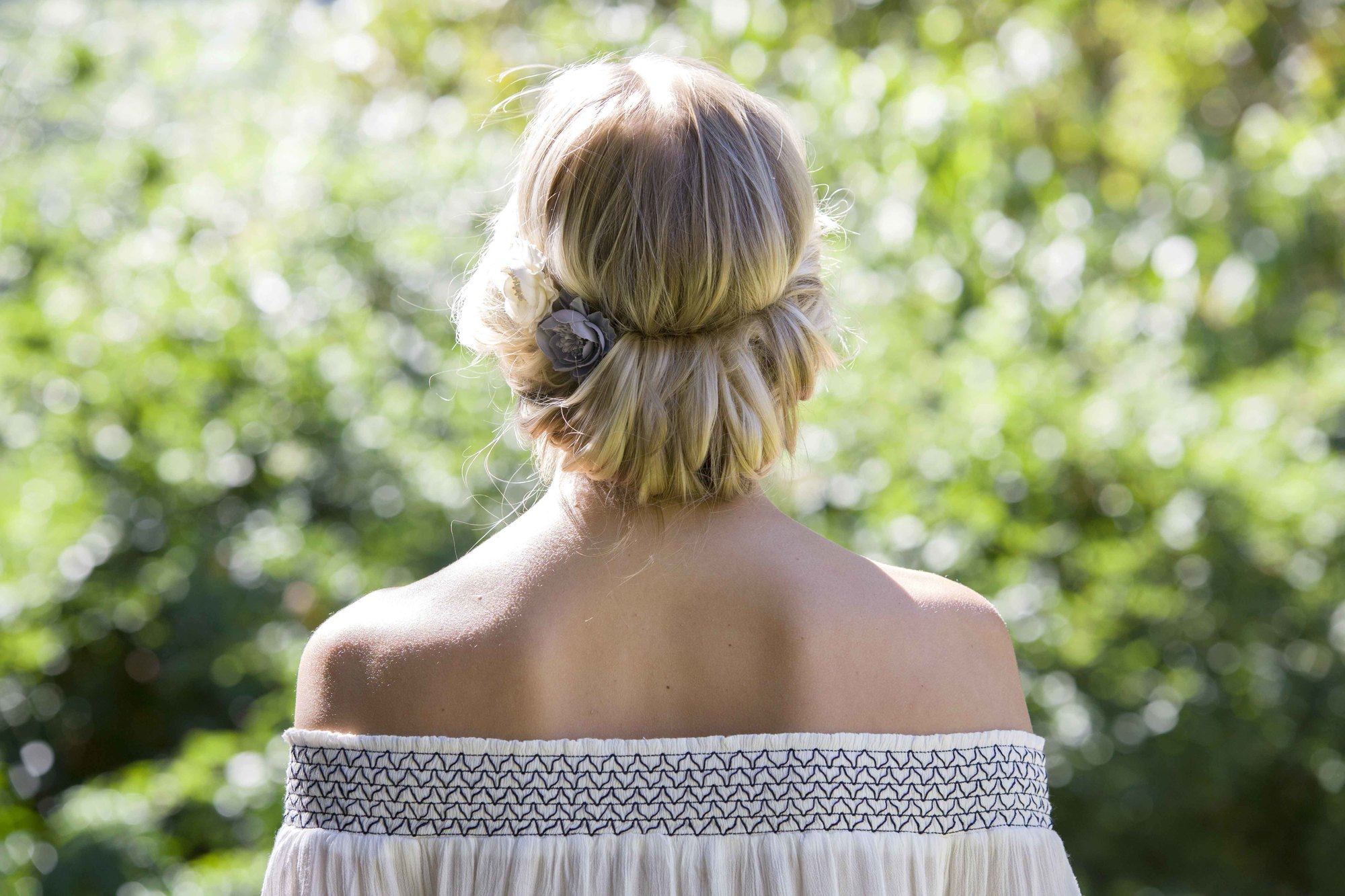 back view of blonde model with hair swept into a chignon