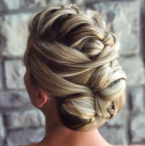 Wedding hairstyles for long hair: Back view of a blonde woman with her hair in a French fauxhawk updo hairstyle