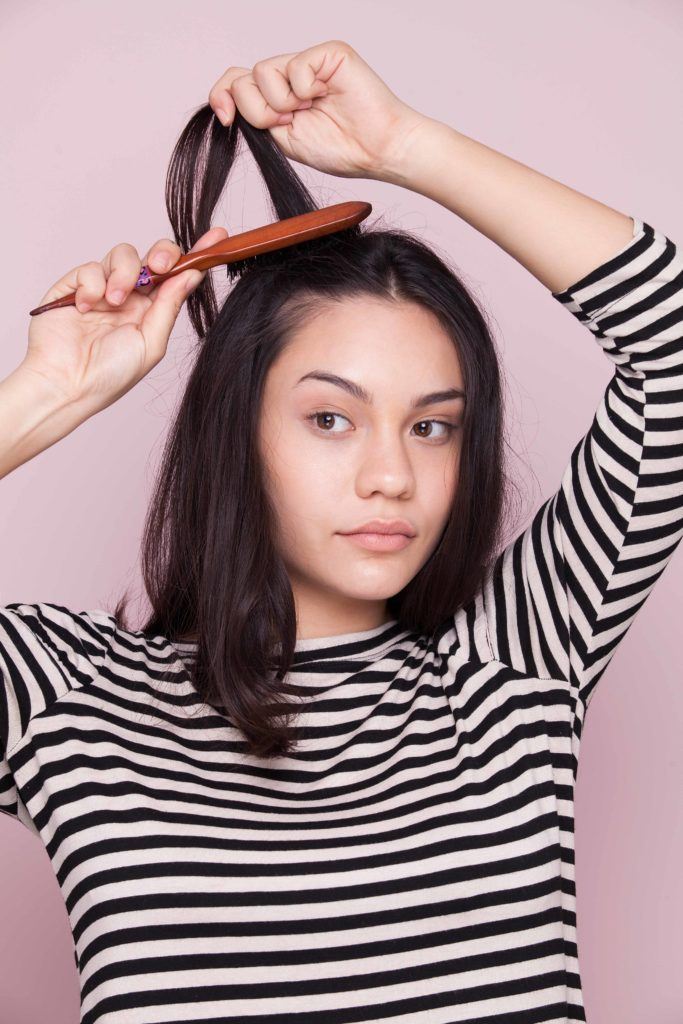 Teasing hair using a brush