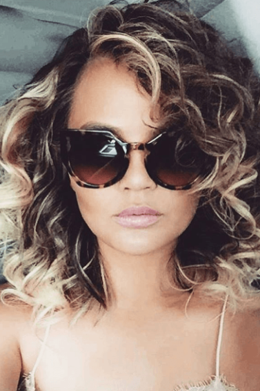 1980s hairstyles Chrissy Teigen new curly hair
