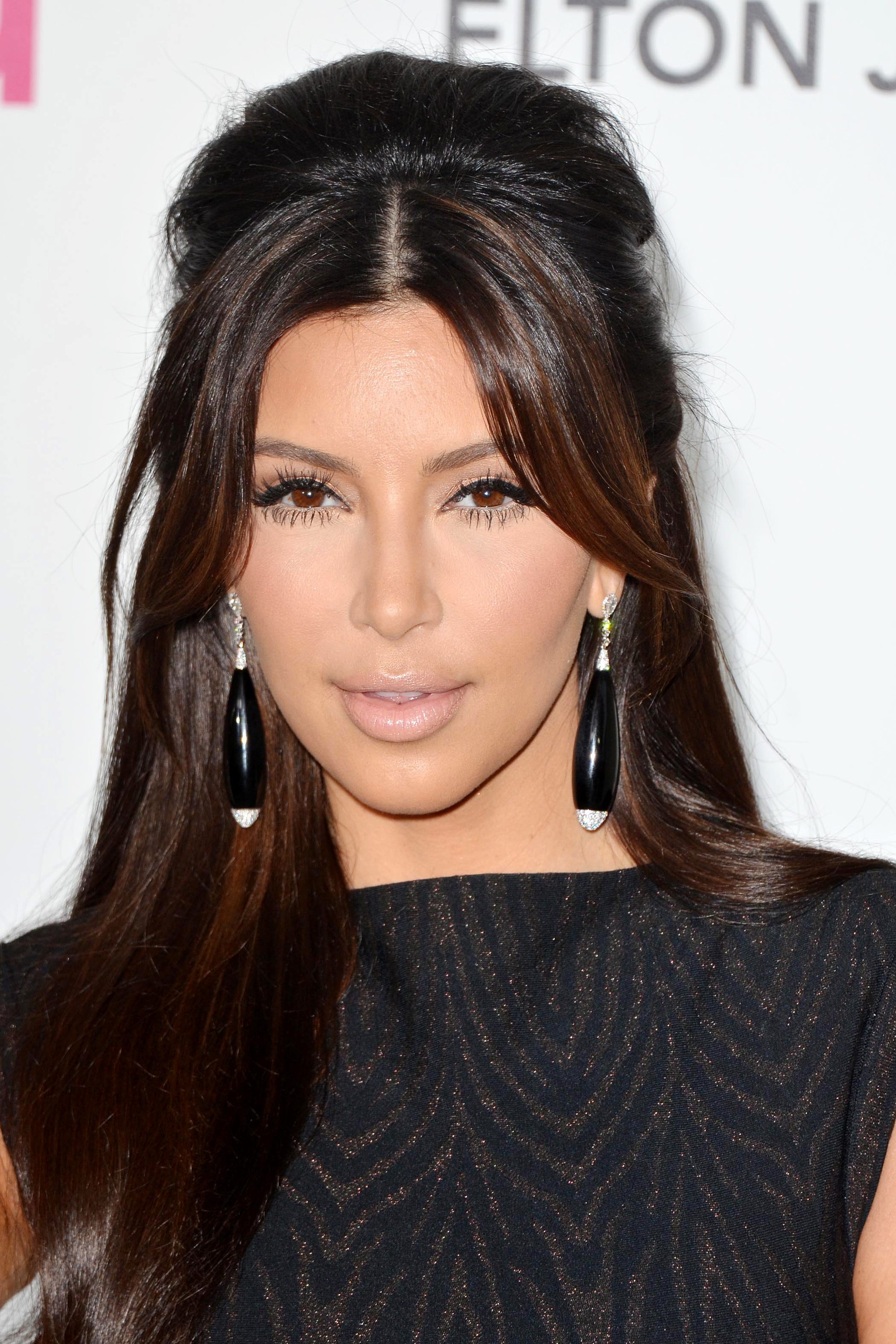 Kim Kardashian dark brown hair half up with bardot bangs