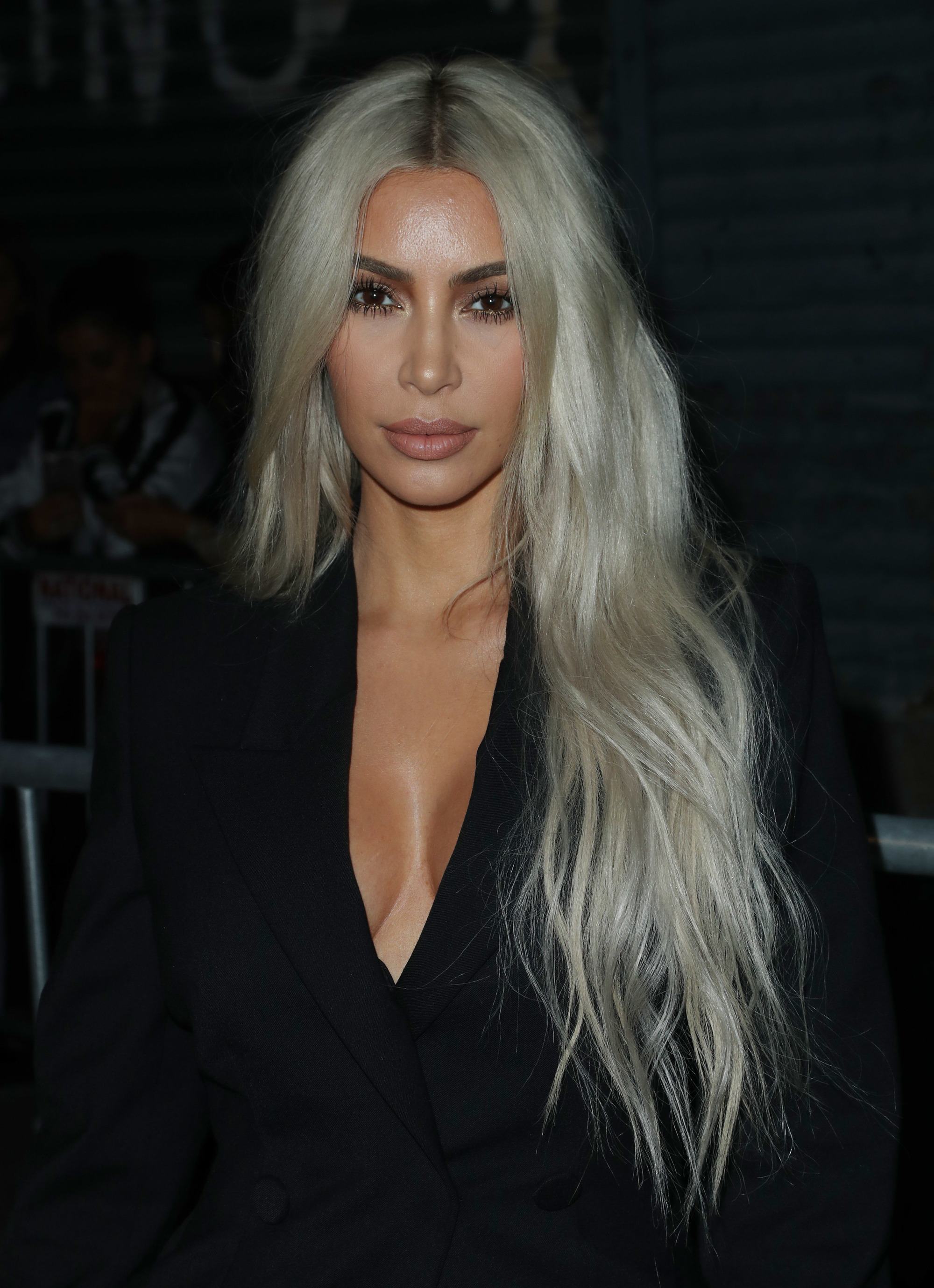 Kim Kardashian rapunzel length silver blonde hair with tousled waves over one shoulder