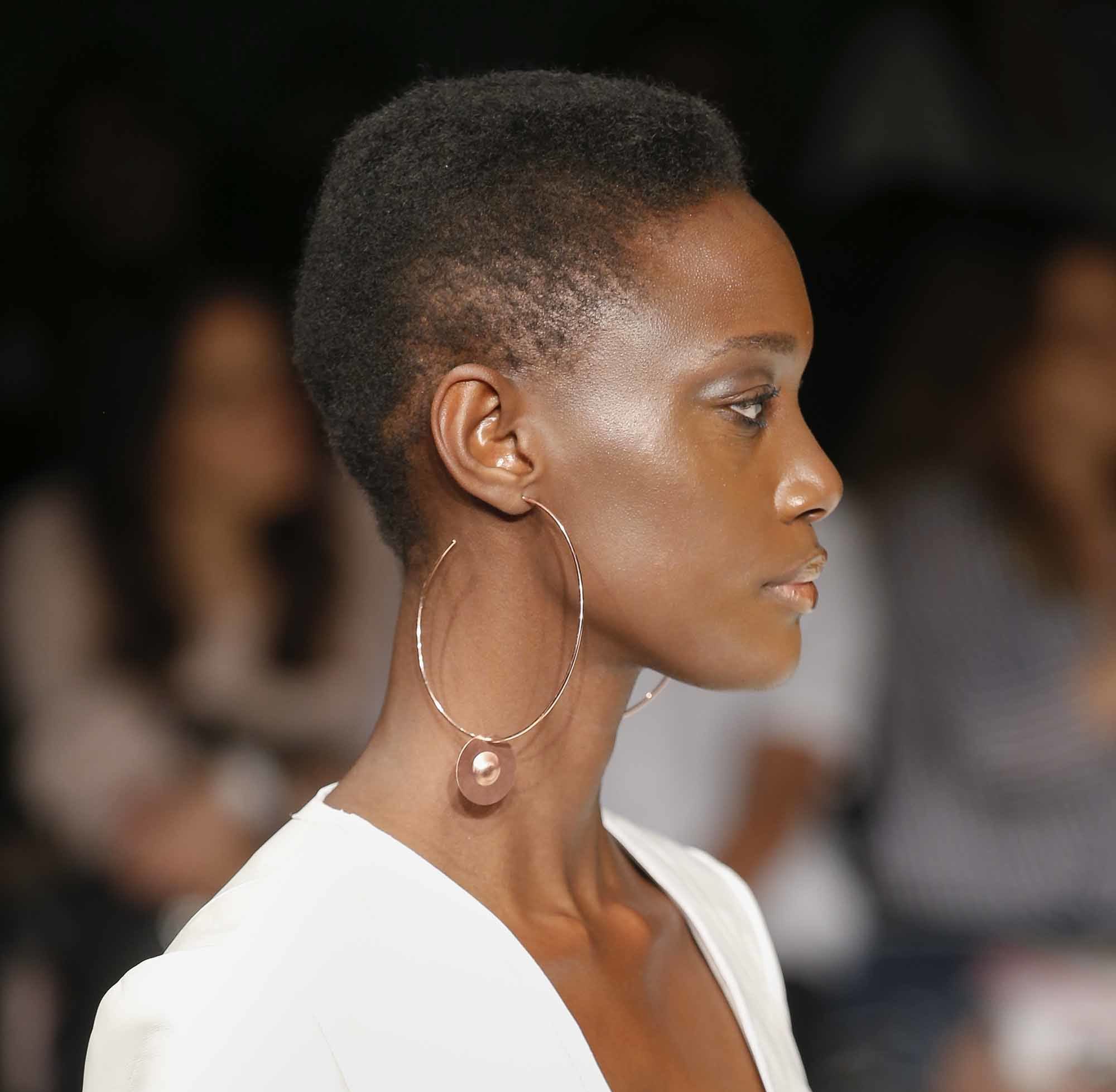 side profile of model with short mohawk afro natural brown hair and oversized hoop earrings at aw16 fashion week show