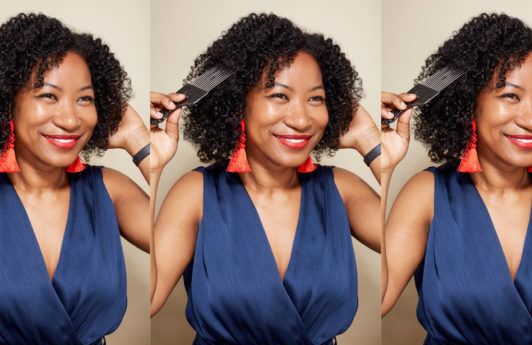 World Afro Day: A young black woman with natural hair and afro pick