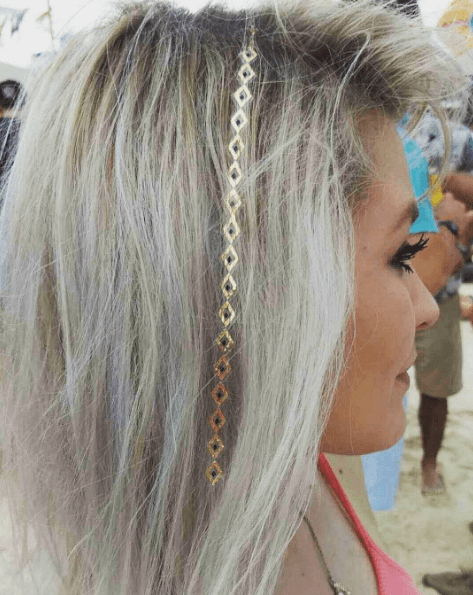woman with dyed grey hair and a temporary silver tattoo