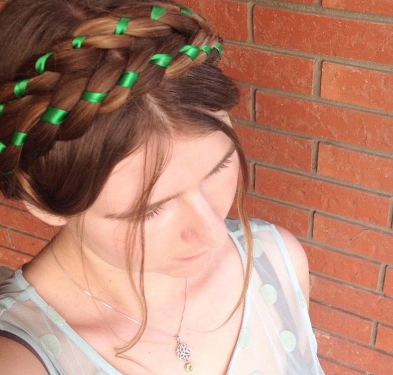 woman with milkmaid braid with ribbon weaved through