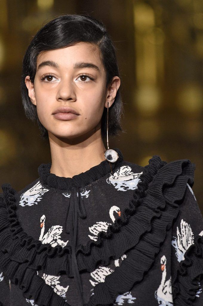 Hairstyles for round face: mixed race woman with a side parting bob