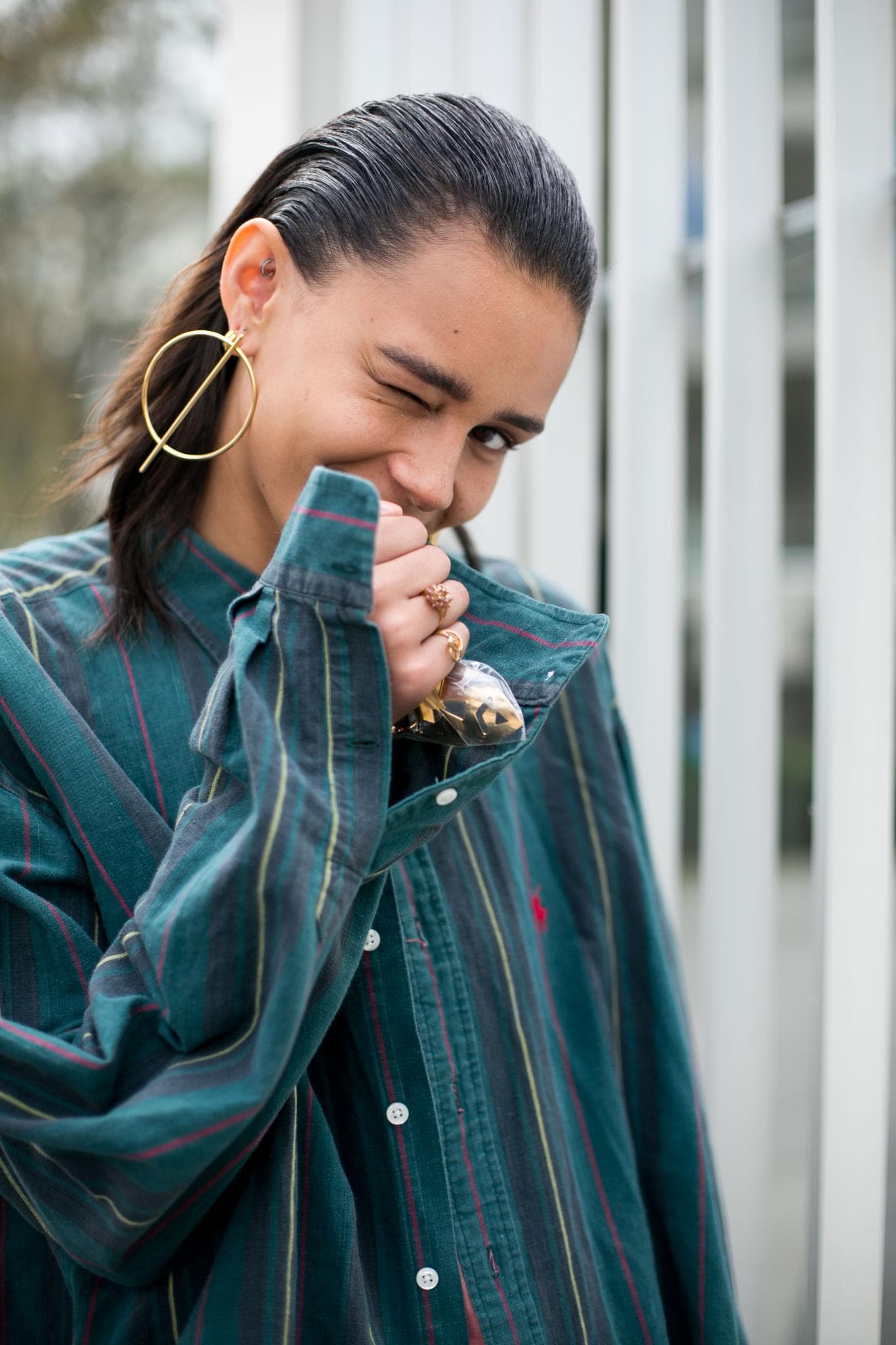 Woman with slicked back hair on streets in Paris coconut oil for hair