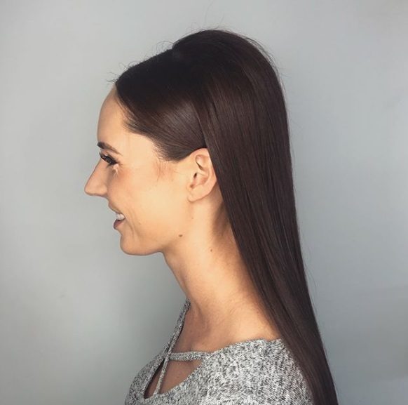 Wedding hairstyles for long hair: Side view of a woman with straight long dark hair with a bouffant