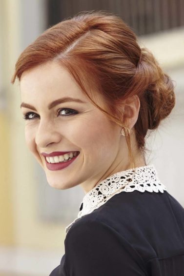 Happy redhead with twist updo hairstyle