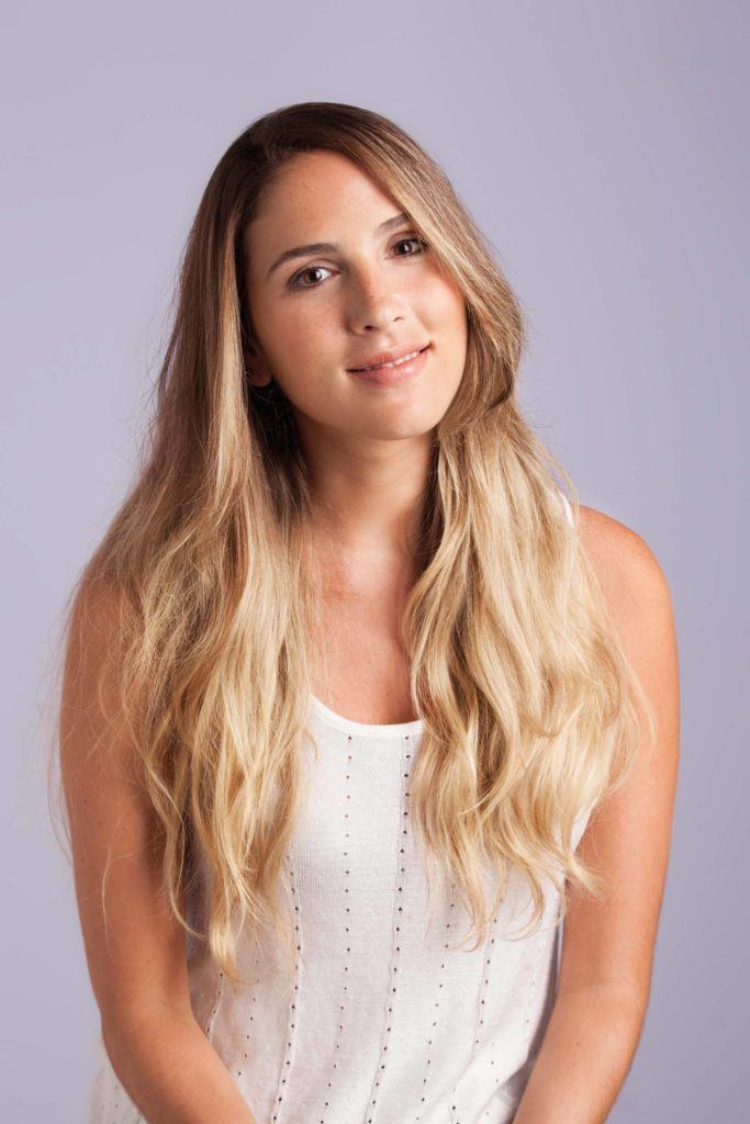 a cute blonde woman on the purple background