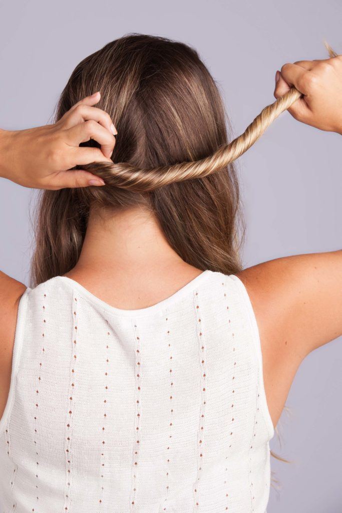 a woman twisted her long blonde hair