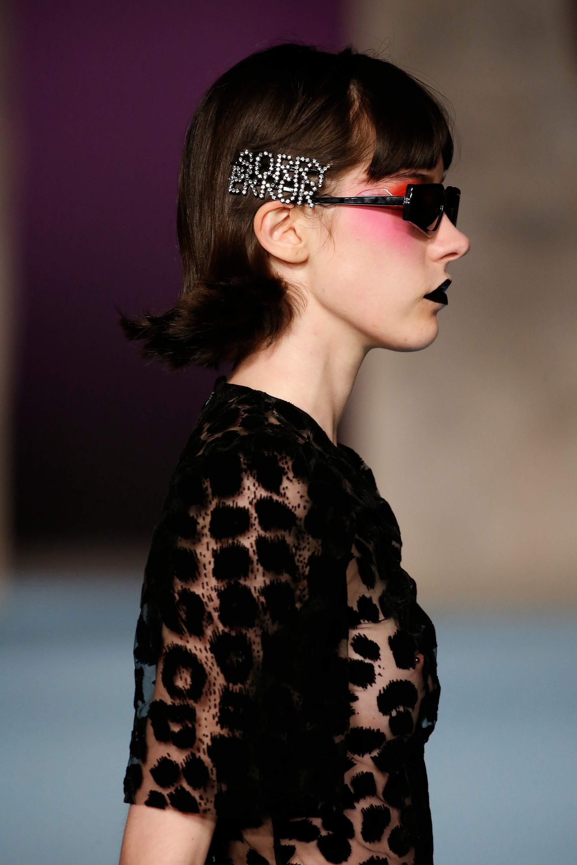 Grown out bangs: Model at ashley williams aw18 show with sorry error hairclip wearing a black spotted outfit