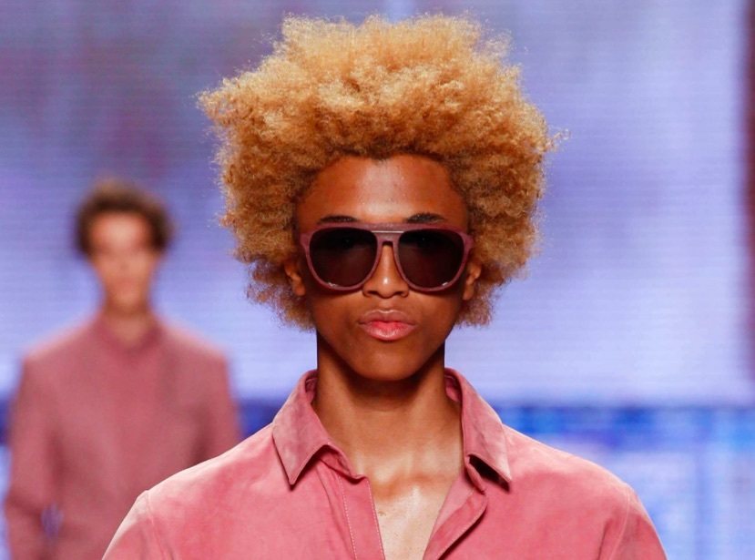 front facing image of a black man with a colourful afro hairstyle - black men hairstyles