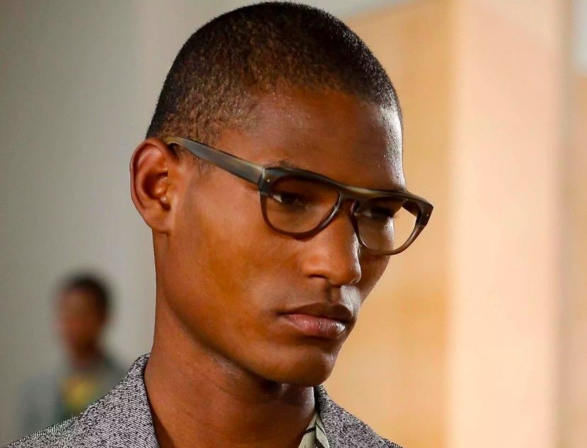 front facing image of a black man wearing glasses with a buzz cut hairstyle - black men's hairstyles