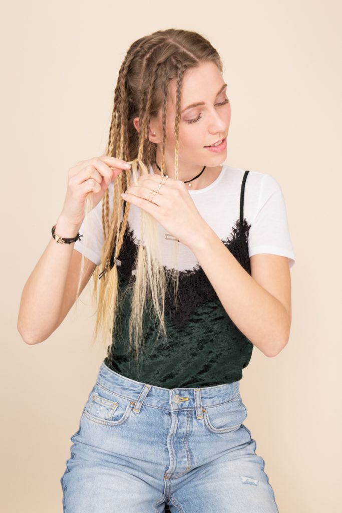 crimped hair tutorial: Blonde model plaiting small braids