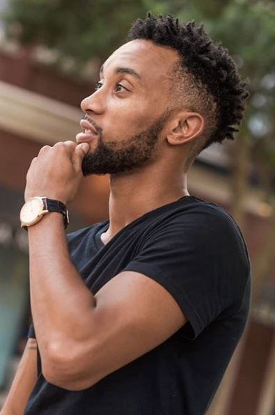 black man touching his chin with a frohawk hairstyle from Instagram @dreasvision
