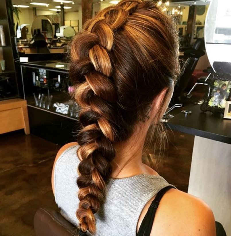 back view image of a woman with a french braid faux hawk braid with two tone hair