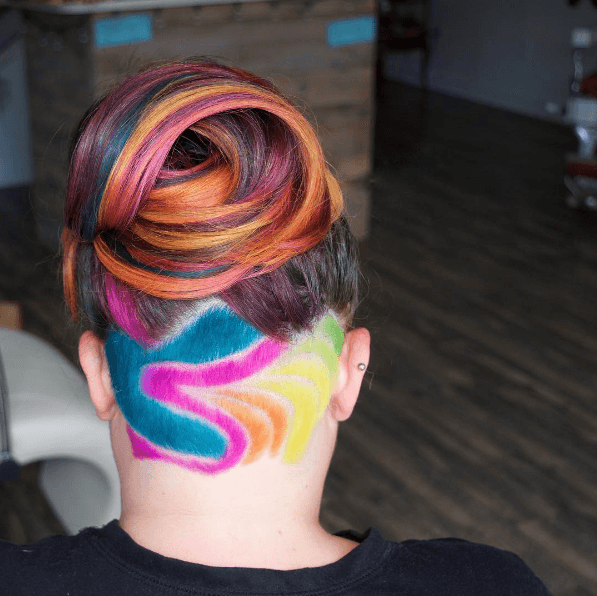 undercut tattoo and rainbow colours on woman with an undercut