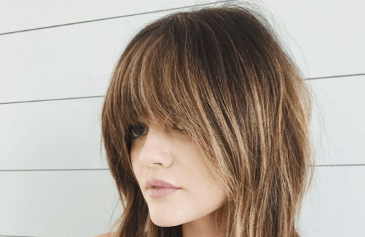 pretty little liars actress lucy hale with a shaggy brunette cut and soft full bangs