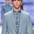 long piecey fringes on male model wearing a blue suit on a catwalk