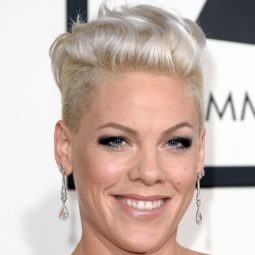 singer Pink on the red carpet with her hair worn in a platinum blonde quiff and an undercut, wearing droplet earrings