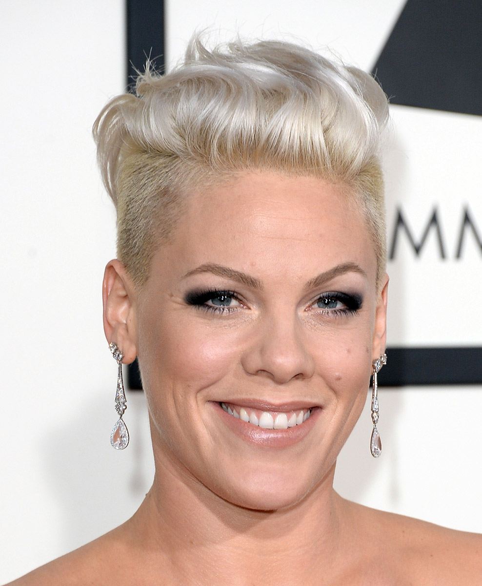 singer Pink on the red carpet with her hair worn in a platinum blonde quiff and an undercut, wearing droplet earrings