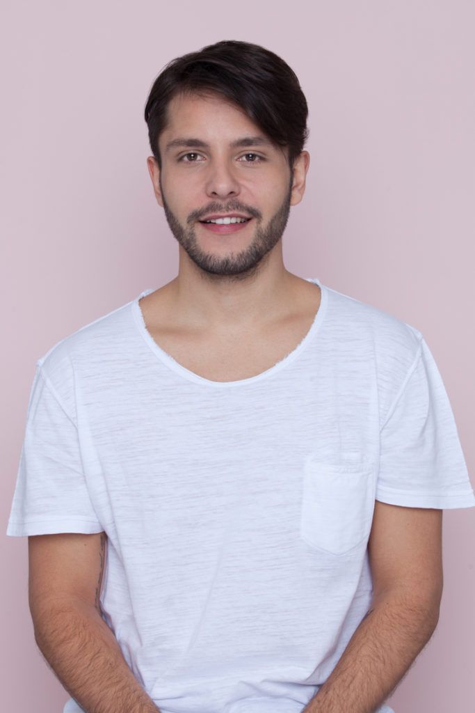a photo of a man with side bangs on the pink background