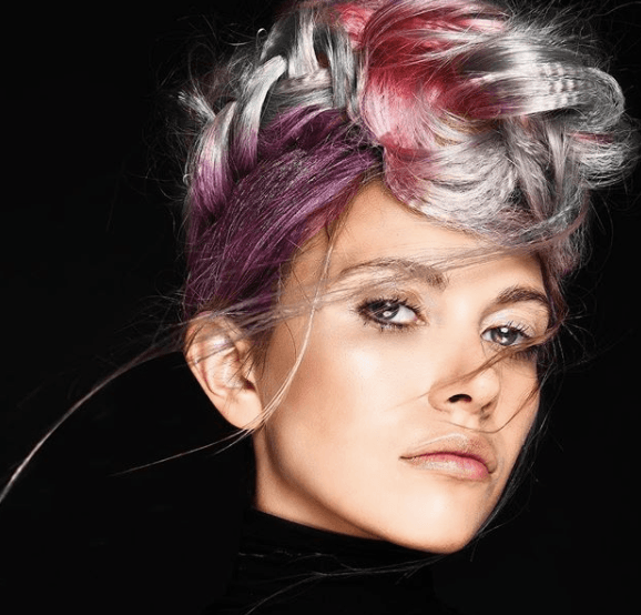 front view of a woman with colourful hair in a braided mohawk style