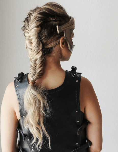 back view image of a woman with long blonde hair in a fishtail braid - faux hawk braid