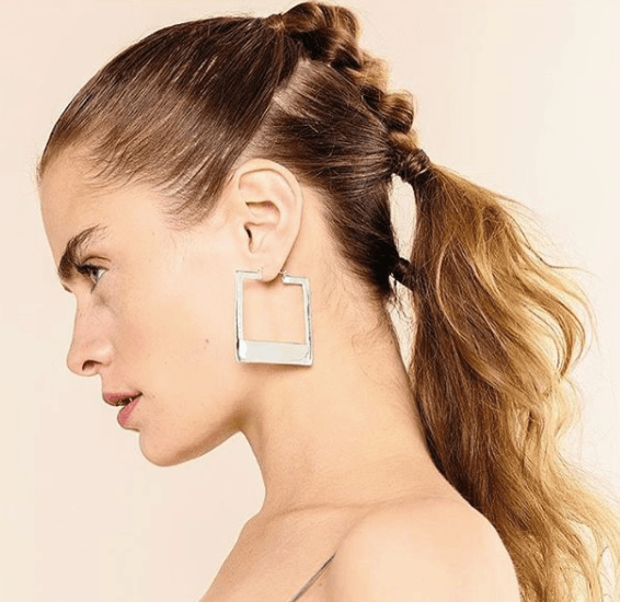 side view of a model with dark blonde hair in braids - faux hawk braid