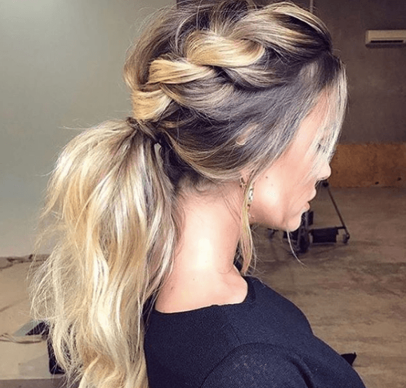 back view of a woman's blonde hair in a loose braid - faux hawk braid