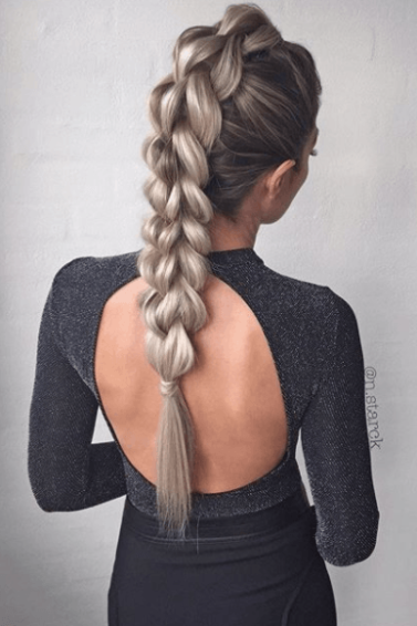 back view of a woman with long blonde braided hair - faux hawk braid