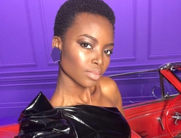close up shot of maria borges with short afro hairstyle, wearing black dress