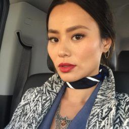 Jamie Chung selfie wearing a black and white coat zig-zag coat and a neck scarf with dark brown hair worn in an updo