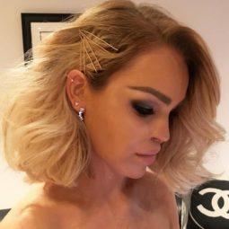 Katie Piper taking a selfie with her blonde hair styled into a bob with bobby pins