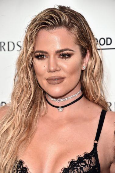 Khloe Kardashian with her long blonde hair worn in a wet look hairstyle