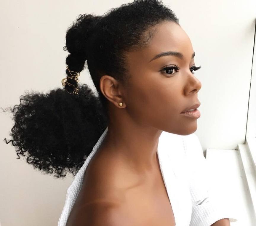 close up shot of gabrielle union with ponytail puff hairstyle posing