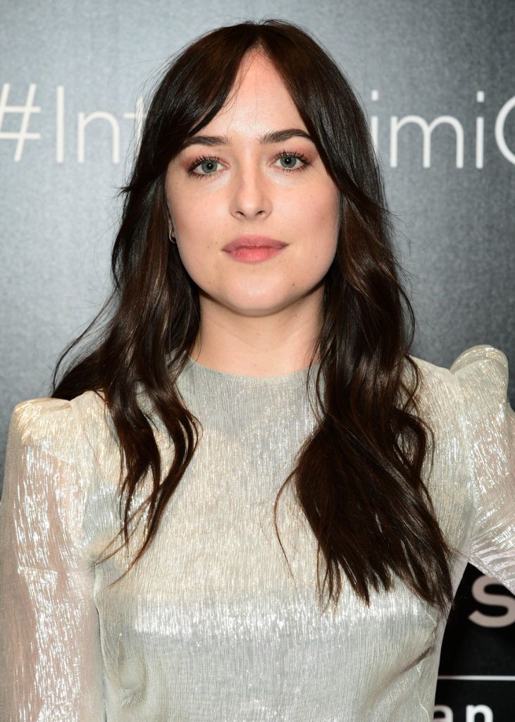 image of Dakota Johnson with her hair worn long and dark - blonde brown hair