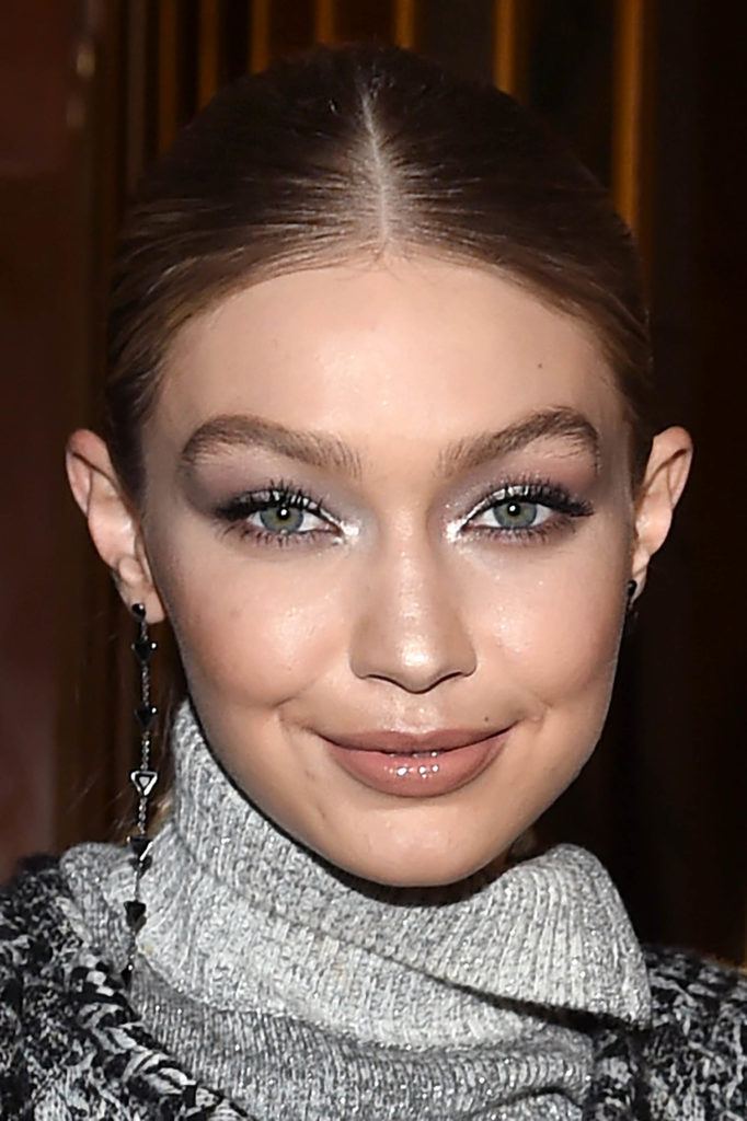image of Gigi Hadid with her hair in a centre parting with brown, blonde hair colour.