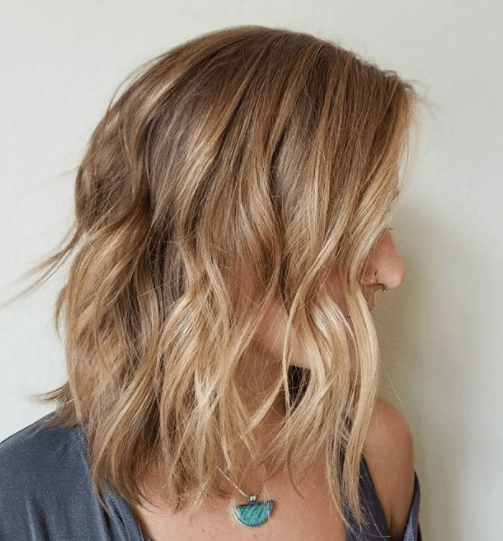 side view image of a woman with warm blonde balayage hair - blonde brown hair